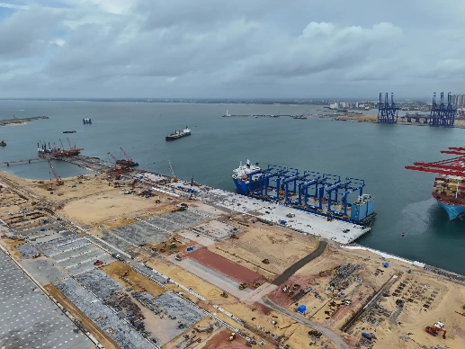Harbor with docked ships, construction, and cranes.