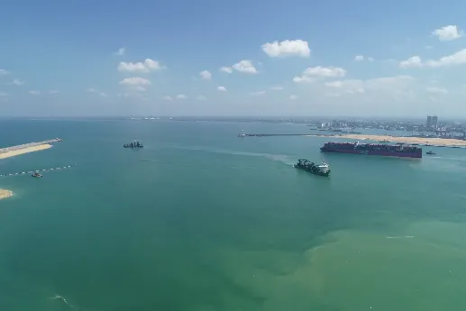 A working vessel and a container vessel near the CWIT berth.