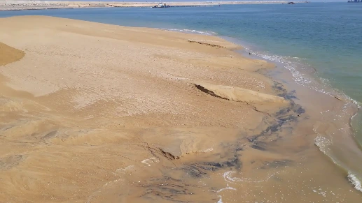 The beach with clear sand and water.